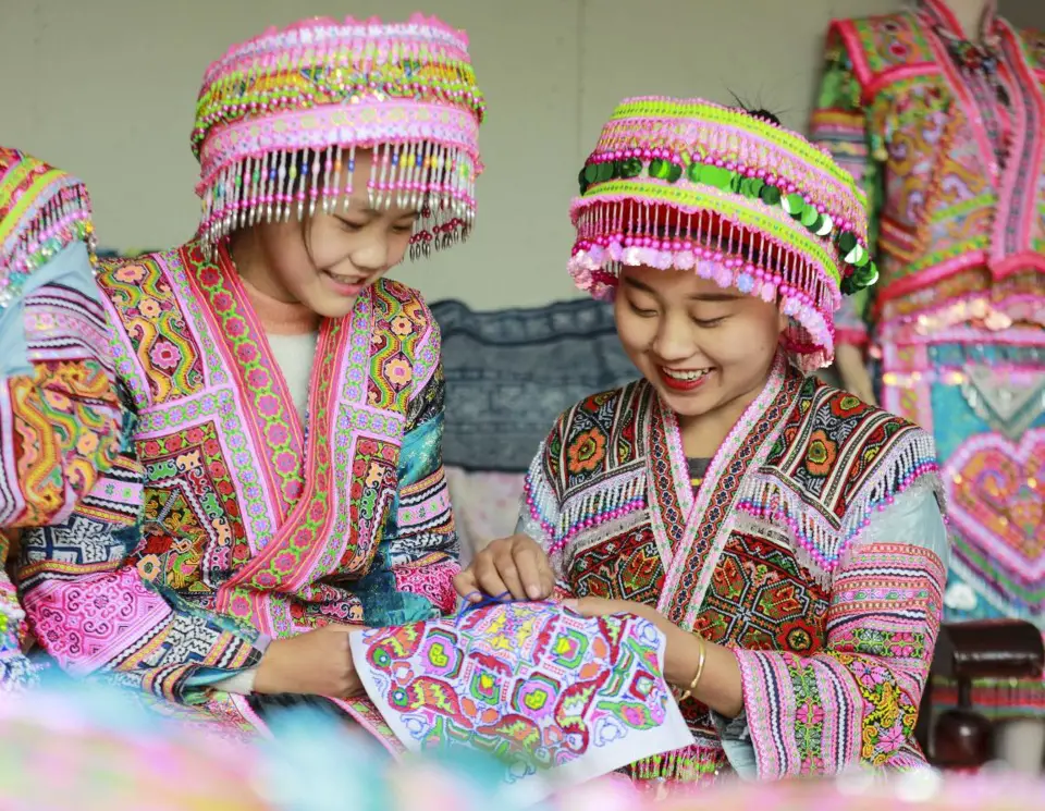 Women of Miao ethnic group embroider at a workshop in Honglin Yi and Miao township, Qianxi city, southwest China’s Guizhou province, Nov. 14, 2021. (Photo by Zhou Xunchao/People’s Daily Online)