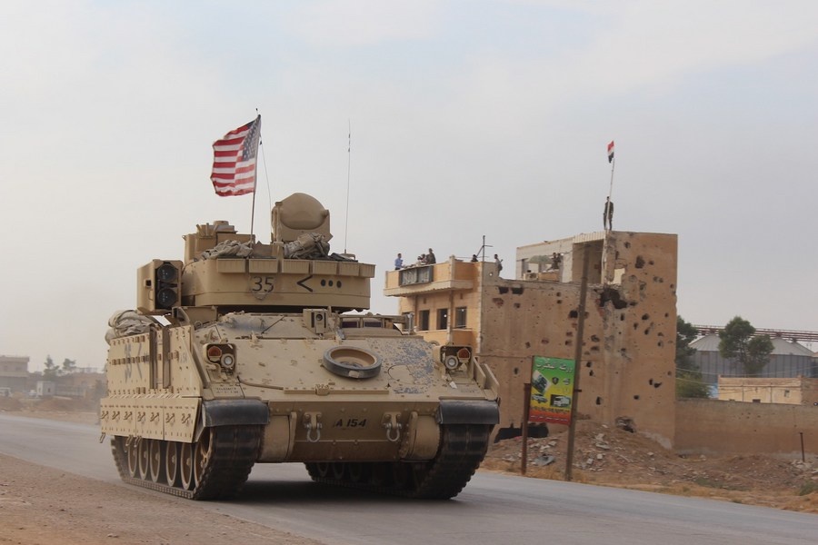 A U.S. military vehicle runs past the Tal Tamr area in the countryside of Hasakah province, northeastern Syria, on Nov. 14, 2019. (Str/Xinhua)