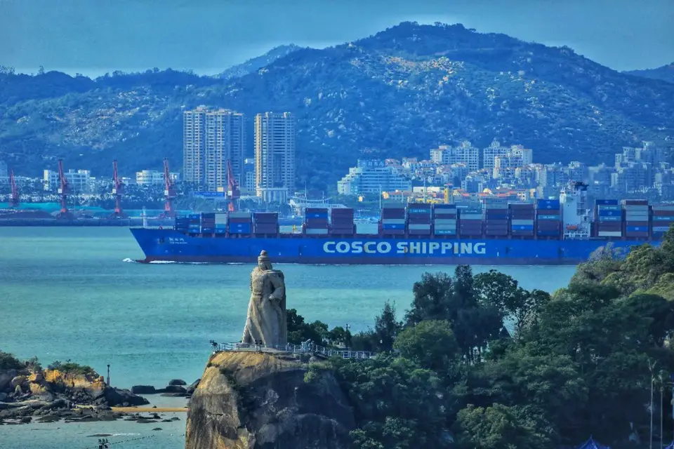 A cargo vessel sails near Gulangyu Island in Xiamen city, southeast China’s Fujian province. (Photo by Zhou Daoxian/People’s Daily Online)