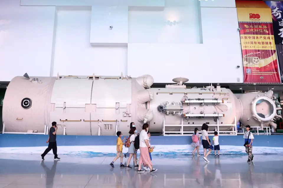 Parents and children watch a life-size model of the Tianhe core module of China’s space station at the China Science and Technology Museum in Beijing, June 30, 2021. (Photo by Chen Xiaogen/People’s Daily Online)