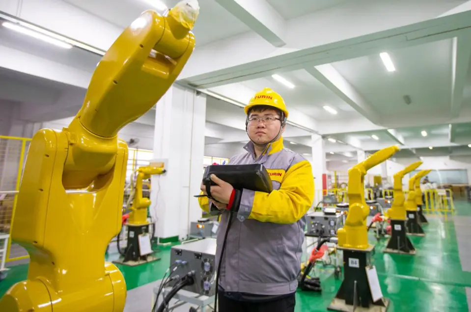 Industrial robots are being tested at a workshop of a robot manufacturer in Hai'an Economic and Technological Development Zone, east China's Jiangsu province, Jan. 5. (Photo by Zhai Huiyong/People's Daily Online)