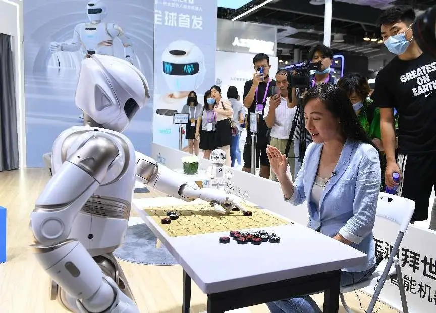 A visitor plays Chinese chess with a humanoid robot at the 2021 World Artificial Intelligence Conference, July 7, 2021. (Photo by Yang Jianzheng/People’s Daily Online)