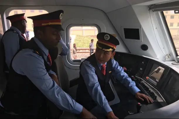 A Chinese train driver instructs an Ethiopian train driver in train driving. (Photo courtesy of China Railway No.2 Engineering Group)