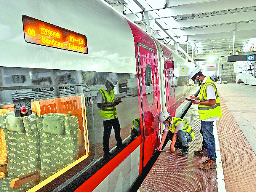 Technicians work at a train station along the Jakarta-Bandung High Speed Railway in Indonesia. (Photo by Li Qiang/People's Daily)
