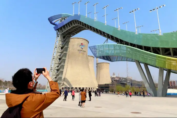 A tourist takes picture of the Big Air Shougang, a venue for the Beijing 2022 Olympic Winter Games in Beijing. (Photo by He Luqi/People's Daily Online)