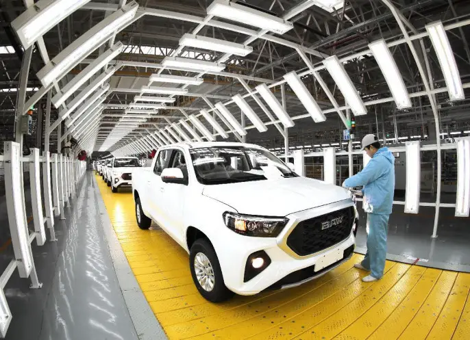 A worker performs pre-delivery inspection for vehicles that have just rolled off the production line in a work shop of a production base owned by Chinese automaker BAIC Motor in Qingdao, east China's Shandong province, Jan. 14, 2023. (Photo by Zhang Jingang/People's Daily Online)