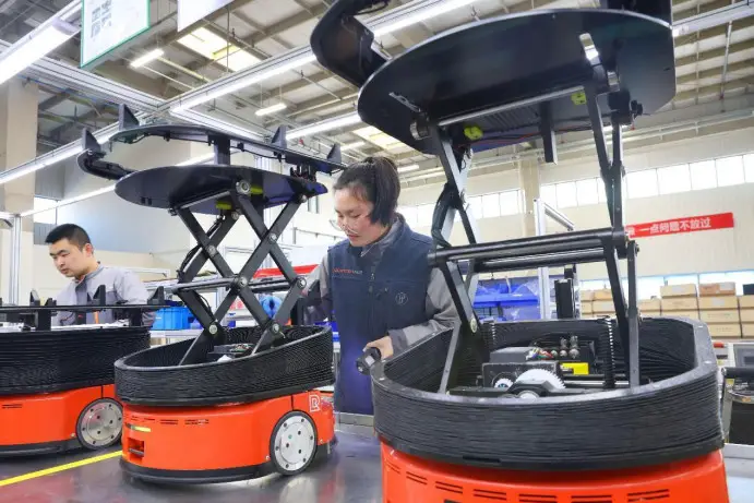 Smart robots go through quality inspection in a workshop of a company in Lujia township, Kunshan, east China's Jiangsu province, March 4, 2023. (Photo by Xu Congjun/People's Daily)