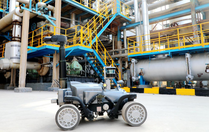 A smart robotic vehicle goes for an inspection tour in a plant of a chemical engineering corporation in Dongying, east China's Shandong province, Feb. 24, 2023. The vehicle is connected to a 5G local area network and equipped with various types of sensors that capture images, sounds, infrared pictures, as well as data of hazardous gases and temperature. It has effectively improved inspection quality and production safety. (Photo by Liu Zhifeng/People's Daily Online)