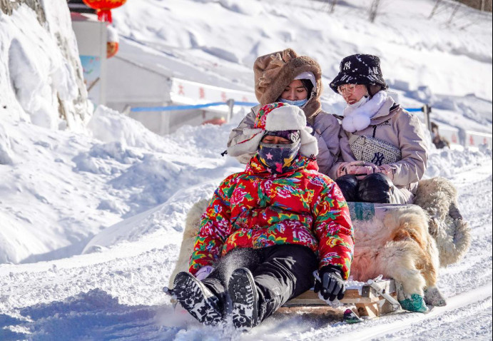 Tourists go sledding at Changbai Mountain scenic area in northeast China's Jilin province, Feb. 2, 2023. (Photo by Lv Haojun/People's Daily Online)