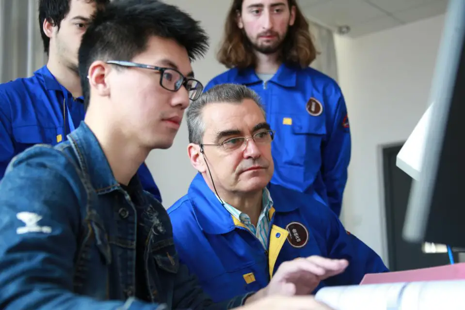 A Chinese teacher (left) introduces mechatronics equipment to Portuguese students and teachers in the Luban Workshop at Polytechnic Institute of Setubal, Portugal. (Photo courtesy of the Luban Workshop at Polytechnic Institute of Setubal)