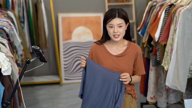 A woman sells garments via live-stream in Changshu, east China's Jiangsu province. (Photo from the official account of the information office of the municipal government of Changshu)