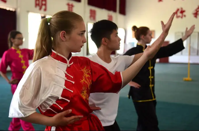 Russian teenagers practice Bajiquan, a traditional martial art, under the instruction of a master in a training base in Cangzhou, north China's Hebei province. (Photo by Fu Xinchun/People's Daily Online)