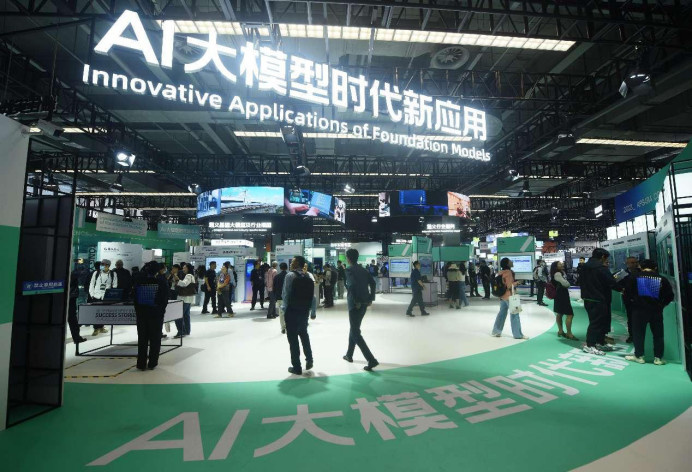 Visitors learn about applications of large artificial intelligence models at the 2023 Apsara Conference in Hangzhou, east China's Zhejiang province, Oct. 31, 2023. (Photo by Long Wei/People's Daily Online)