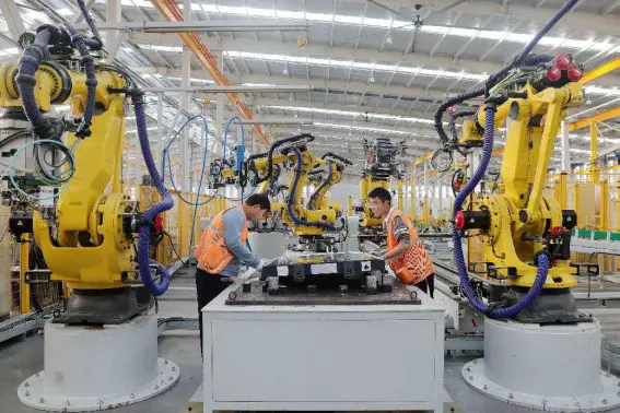 Workers manufacture high-end aluminum alloy parts for new energy vehicles in a workshop of a new material enterprise in Huaibei, east China's Anhui province. (Photo by Wan Shanzhao/People's Daily Online)