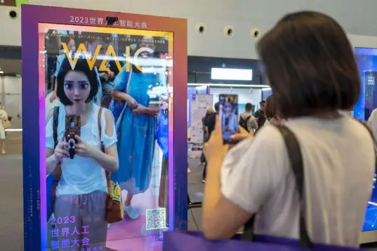 A woman takes pictures of a cartoon image of herself generated by an intelligent application in real time at 2023 World Artificial Intelligence Conference held in east China's Shanghai, July 6, 2023. (Photo by Wang Chu/People's Daily Online)