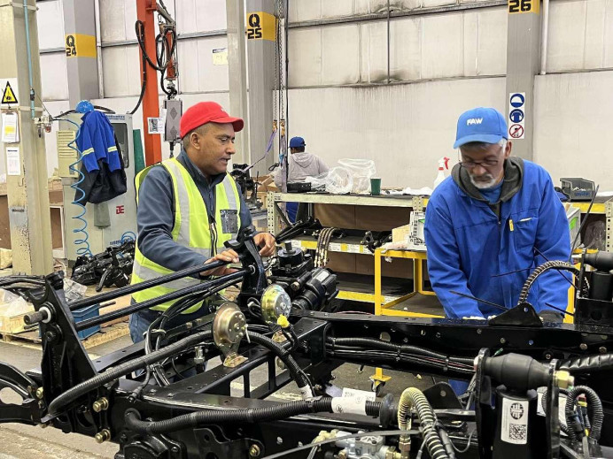 Local employees assemble vehicles in a workshop of the Coega assembly plant of Chinese automaker FAW in South Africa. (Photo by Zou Song/People's Daily)