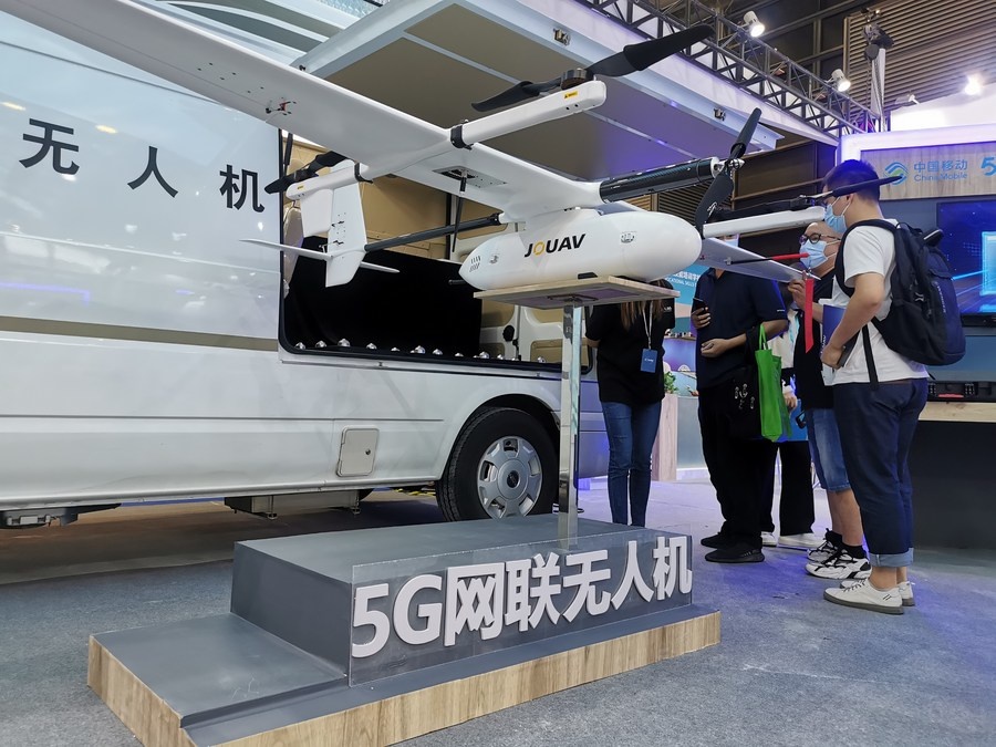 Visitors watch a drone capable of 5G wireless connection at the Drone World Congress 2021 and the Shenzhen International Unmanned Aerial Vehicles (UAV) Expo 2021 in Shenzhen of south China's Guangdong Province, on May 21, 2021. (Xinhua/Wang Feng)