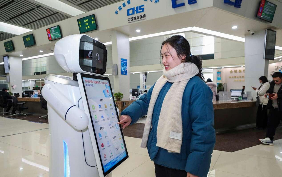 A citizen uses an AI-enabled robot to process medical insurance services at the municipal service center in Huai'an, east China's Jiangsu province. (Photo by Zhao Qirui/People's Daily Online) A citizen uses an AI-enabled robot to process medical insurance services at the municipal service center in Huai'an, east China's Jiangsu province. (Photo by Zhao Qirui/People's Daily Online)