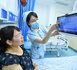 A nurse of Yichun People's Hospital in east China's Jiangxi province reviews a patient's checkup results using a bedside intelligent medical platform. (Photo/Zhou Liang)