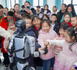 A robot shakes hands with children in Wusu, northwest China's Xinjiang Uygur autonomous region. (Photo/Li Renxi)