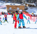 A coach teaches a tourist snowboarding at a ski resort in Yichun, east China's Jiangxi province. (Photo/Zhou Liang)